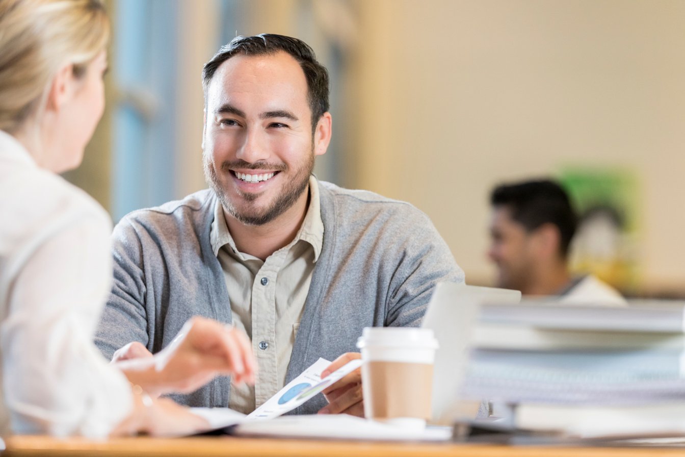 Male accountant reviews document with client